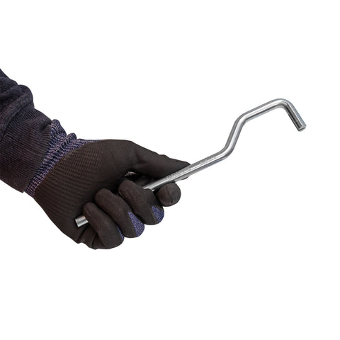Hand wearing a black glove holding a GripTie Tool on a white background